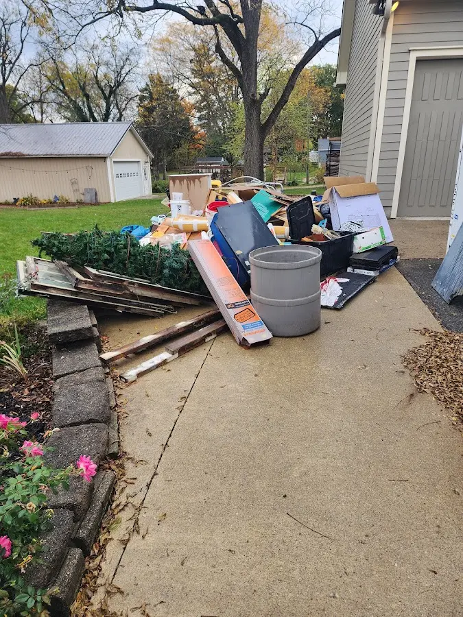 Dumpster being loaded with debris for Demolition Dumpster Rental in Dunn